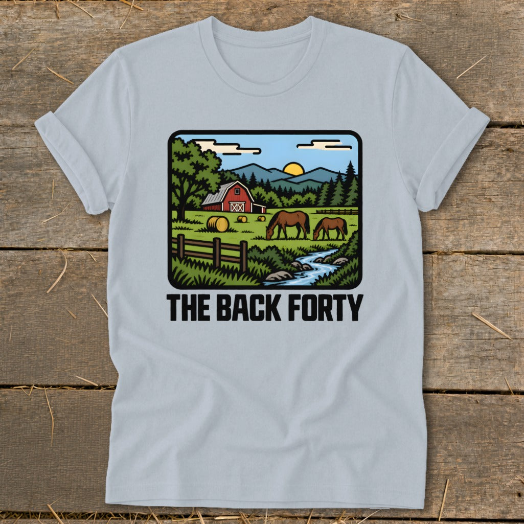 Light blue t-shirt featuring a retro countryside graphic with a red barn, horses, and the text The Back Forty.