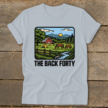 Light blue t-shirt featuring a retro countryside graphic with a red barn, horses, and the text The Back Forty.