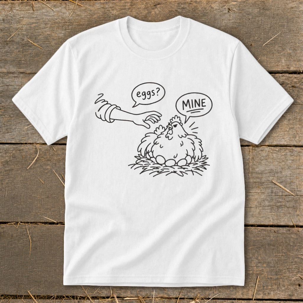 T-shirt with cartoon hen guarding eggs, text "eggs?" and "MINE".