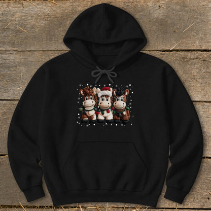 Three cartoon horses in festive scarves and one with a Santa hat on a black hoodie.