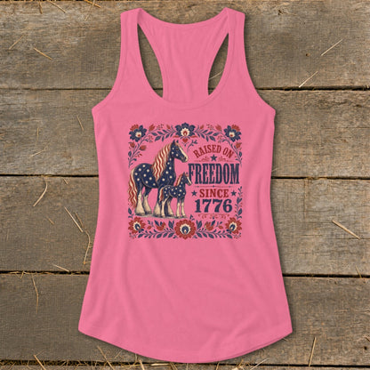 Pink tank top with horses and "Raised on Freedom Since 1776" text.