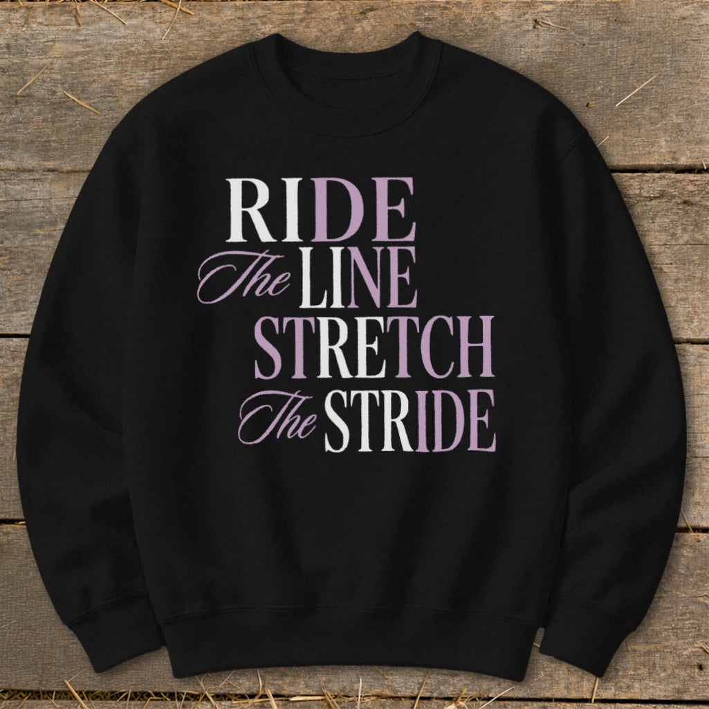 Black sweatshirt with text "RIDE the LINE STRETCH The STRIDE" in white and purple.