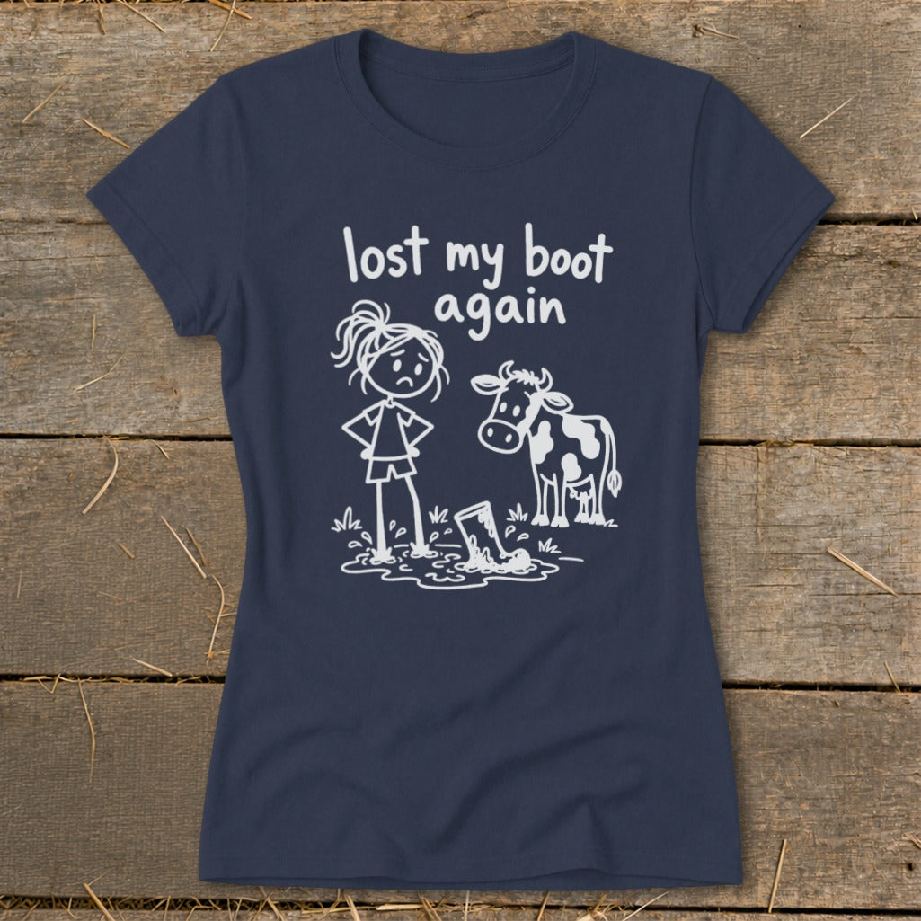Navy blue women's t-shirt featuring a white graphic of a girl, a cow, and the text lost my boot again.