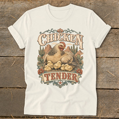 Chicken Tender graphic with hen and chicks in desert landscape, on cream t-shirt.