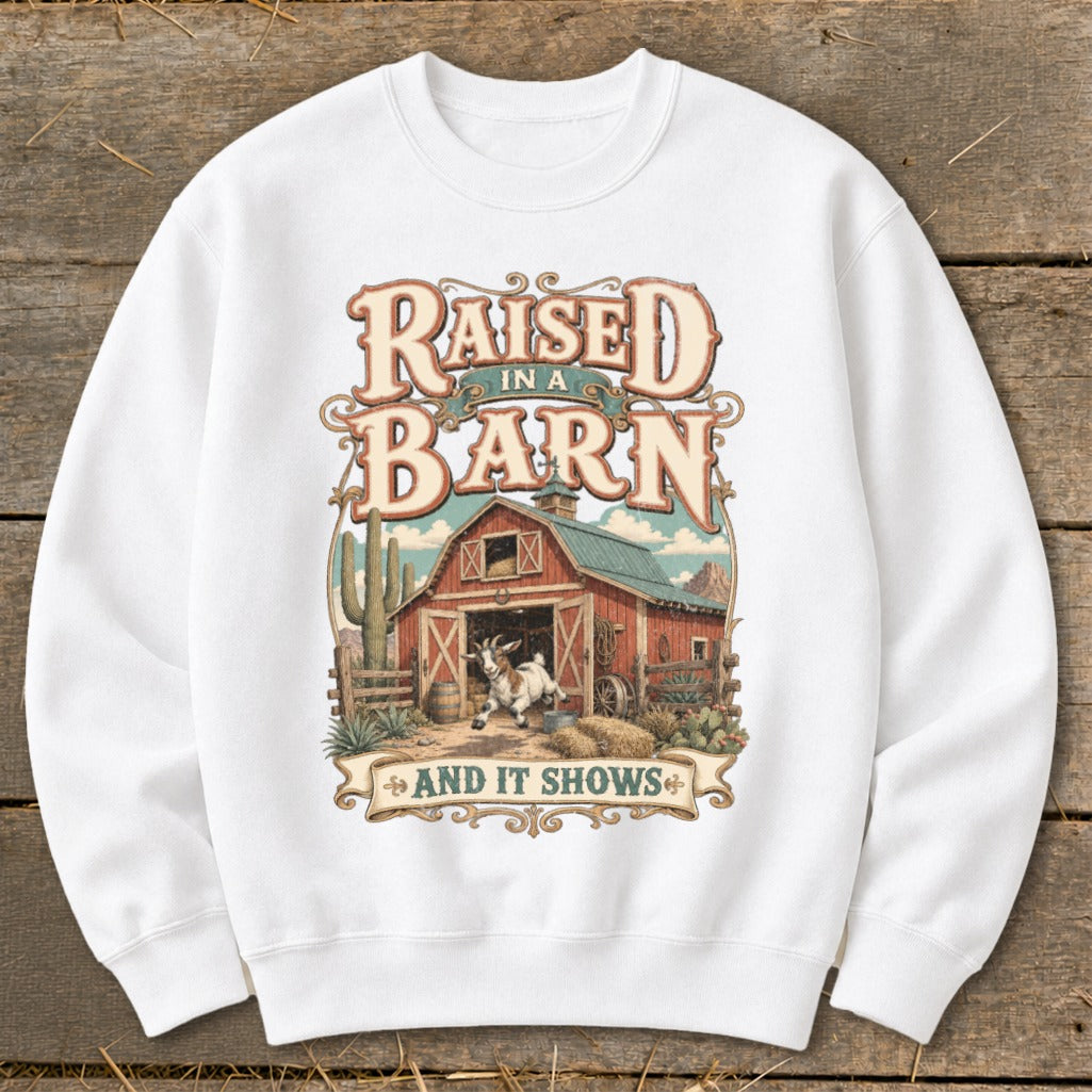 White sweatshirt with "Raised In A Barn And It Shows" text and a barn scene.