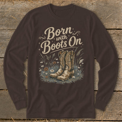 Long-sleeve brown shirt with graphic text "Born with Boots On" and cowboy boots.