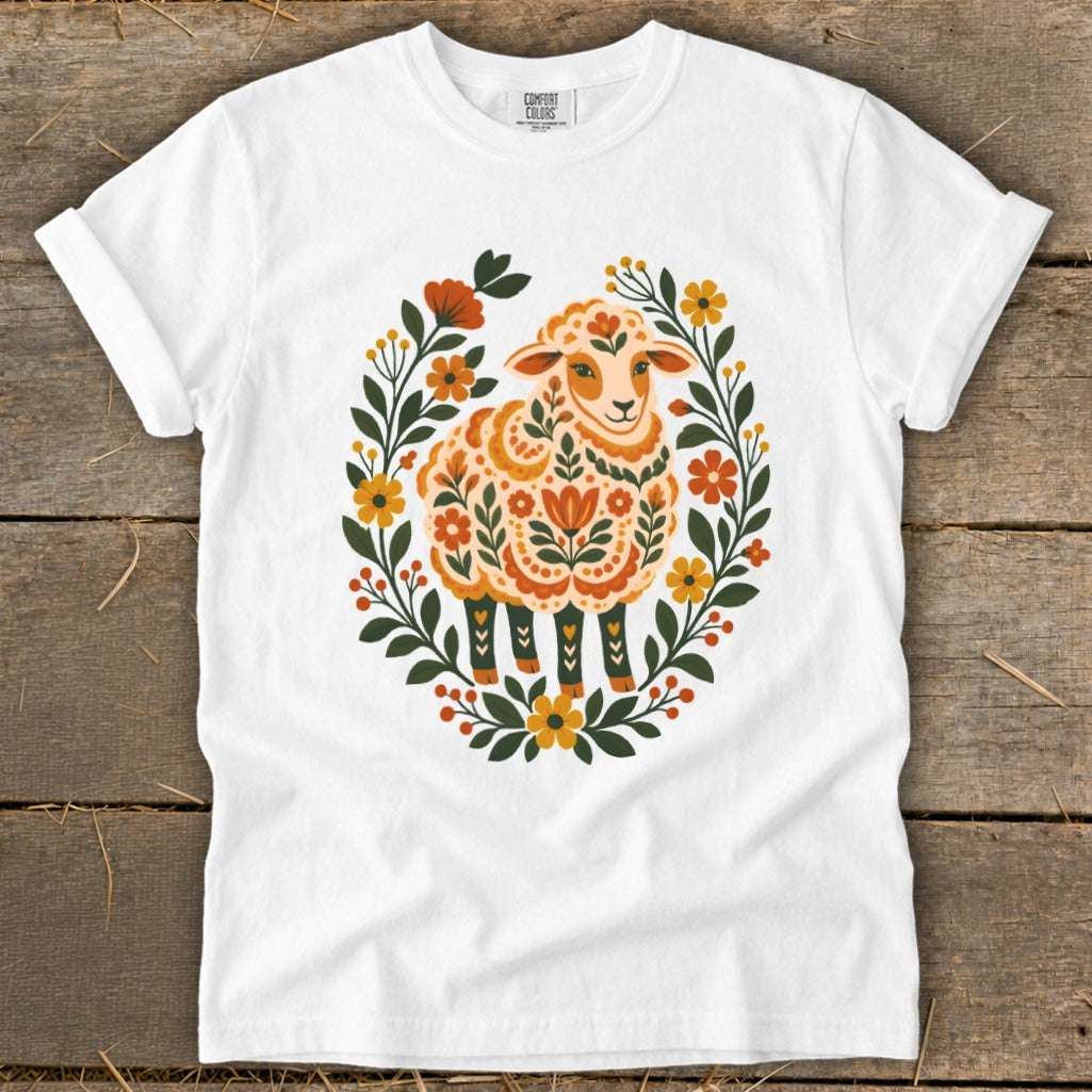 White t-shirt with a sheep design surrounded by floral elements.