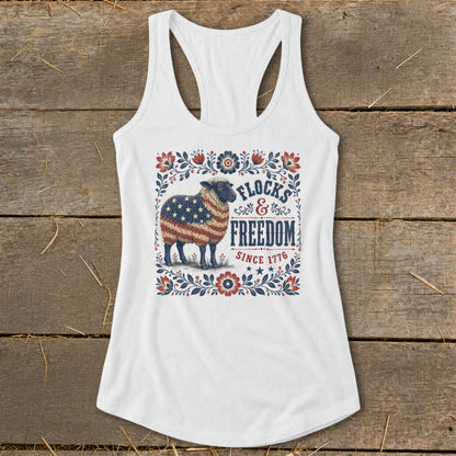 White tank top with a sheep covered in the American flag and "Flocks & Freedom Since 1776" text.