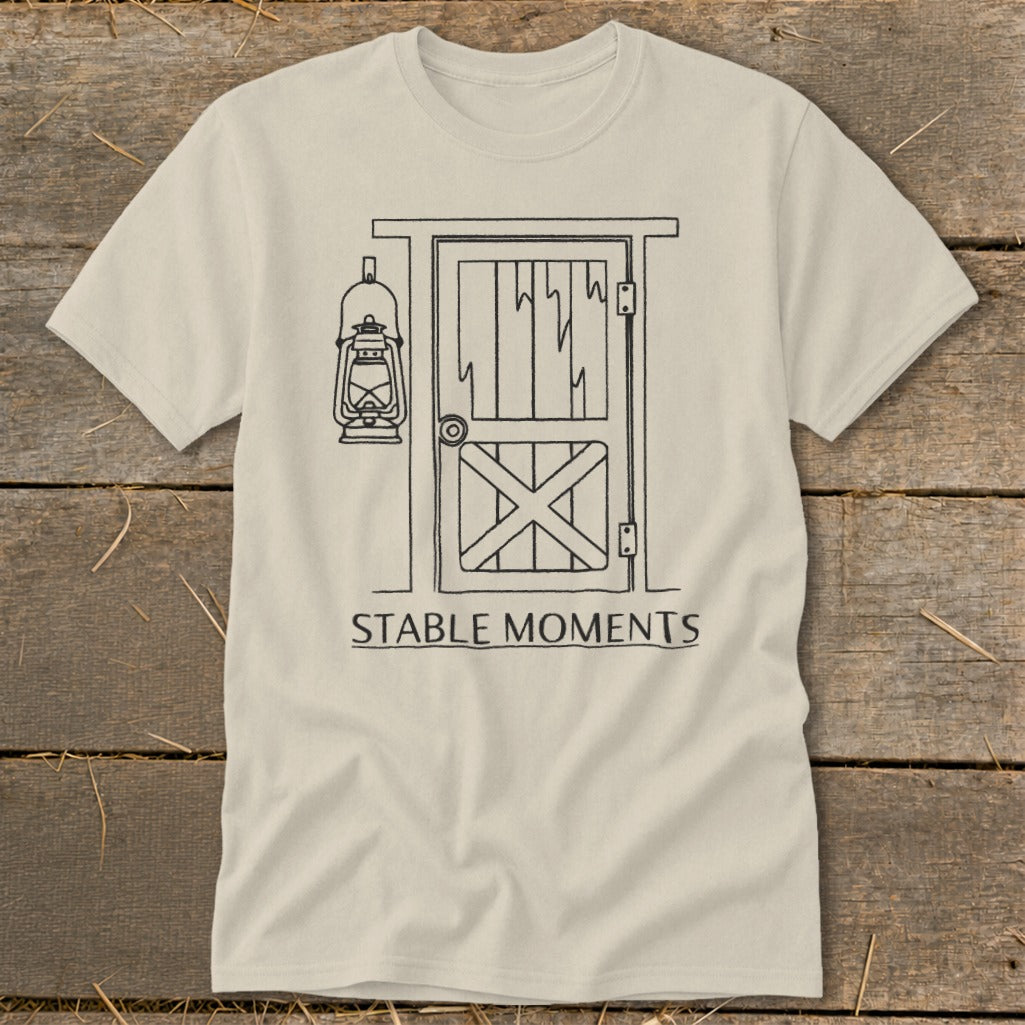 T-shirt with line drawing of stable door, lantern, and text "STABLE MOMENTS".