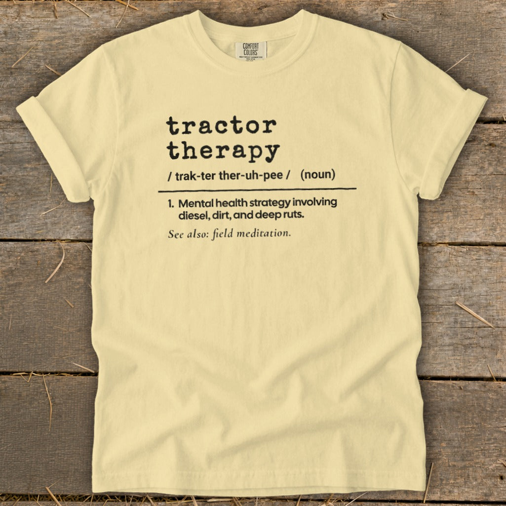 Light yellow t-shirt with black text defining "tractor therapy."