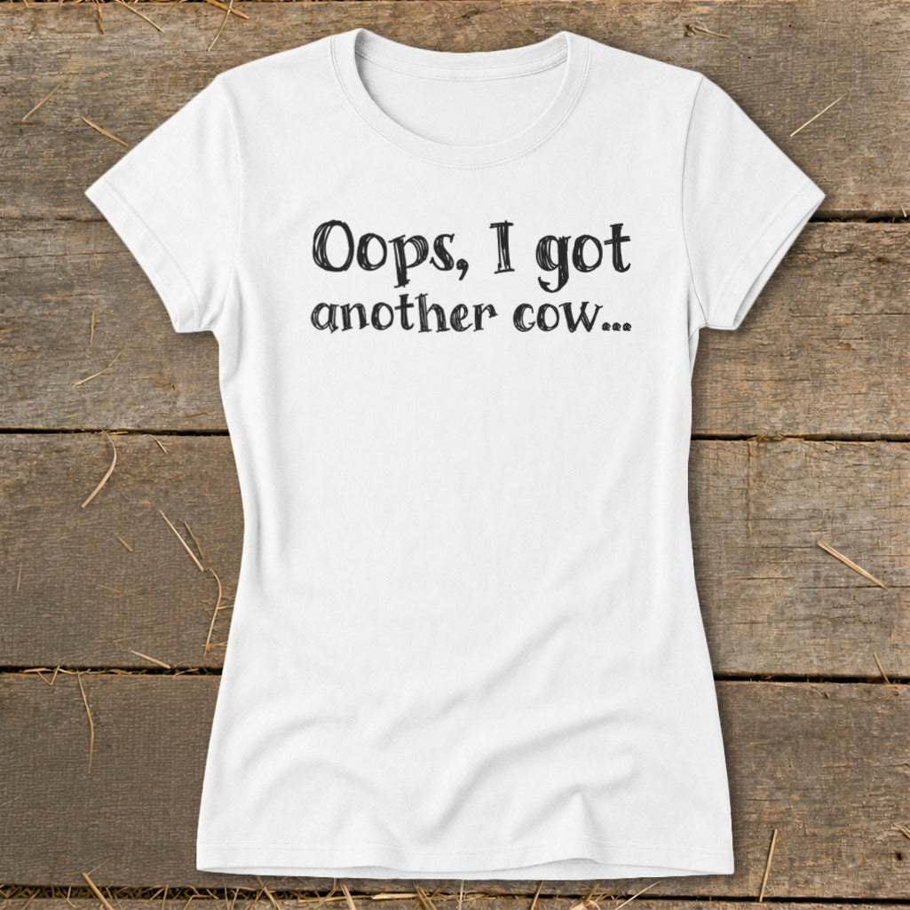 White t-shirt with black text that reads "Oops, I got another cow...".