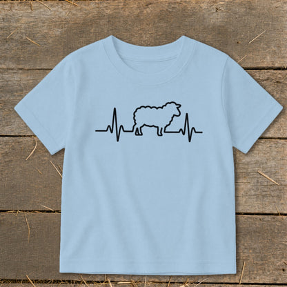 A light blue t-shirt with a black graphic of a sheep integrated into a heartbeat line.