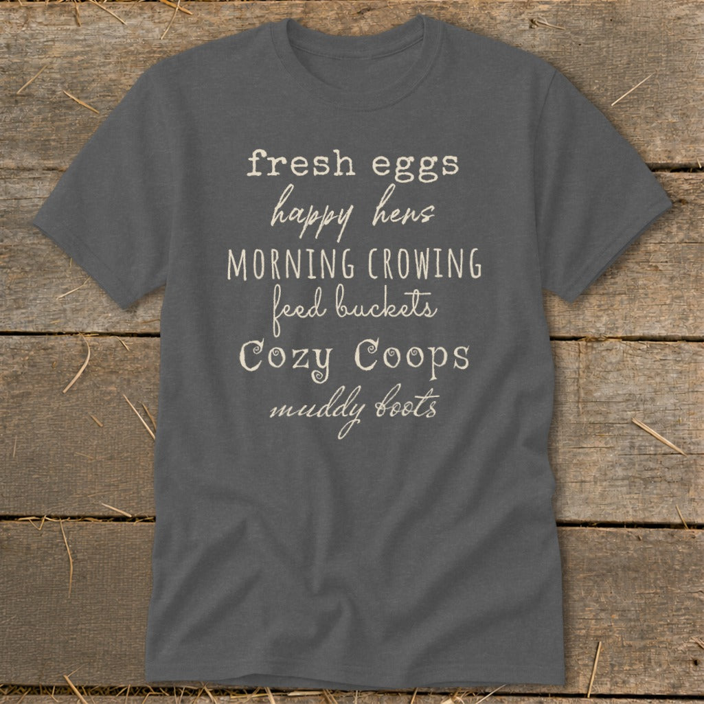 Charcoal t-shirt with white text: "fresh eggs happy hens MORNING CROWING feed buckets Cozy Coops muddy boots".
