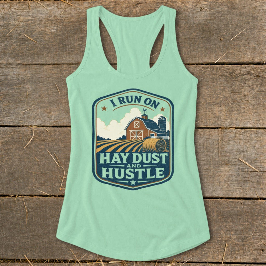 Mint green tank top with "I RUN ON HAY DUST AND HUSTLE" farm graphic.
