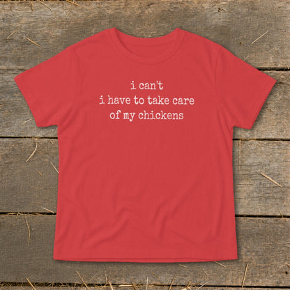 Red t-shirt with white text that reads "i can't i have to take care of my chickens".
