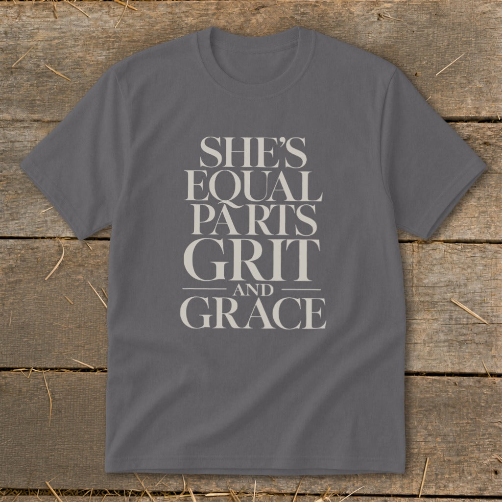 Grey t-shirt with text "SHE'S EQUAL PARTS GRIT AND GRACE".