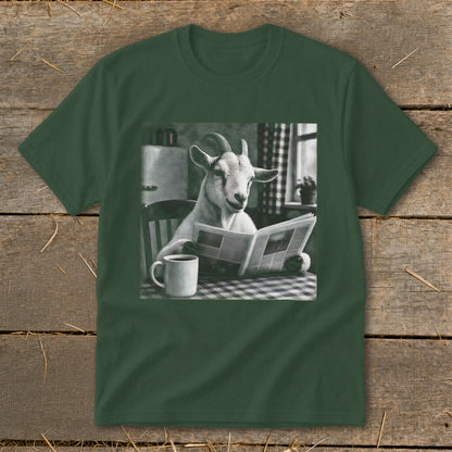 Dark green t-shirt featuring a graphic of a goat sitting at a table reading a newspaper beside a coffee mug.