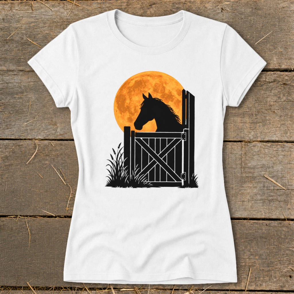 A white t-shirt featuring a silhouette of a horse looking out a stable door against a large orange moon.