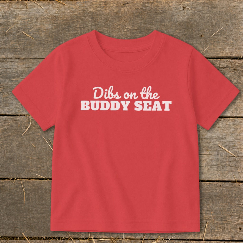 Red t-shirt with white text "Dibs on the BUDDY SEAT".