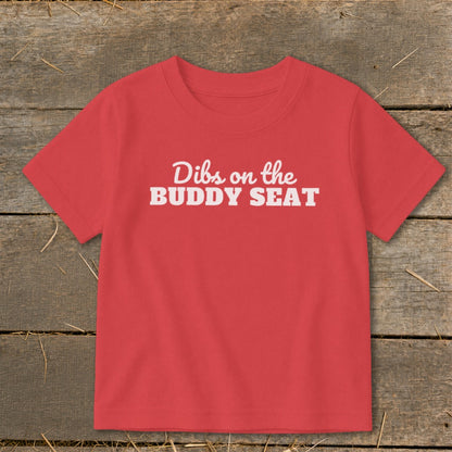 Red t-shirt with white text "Dibs on the BUDDY SEAT".