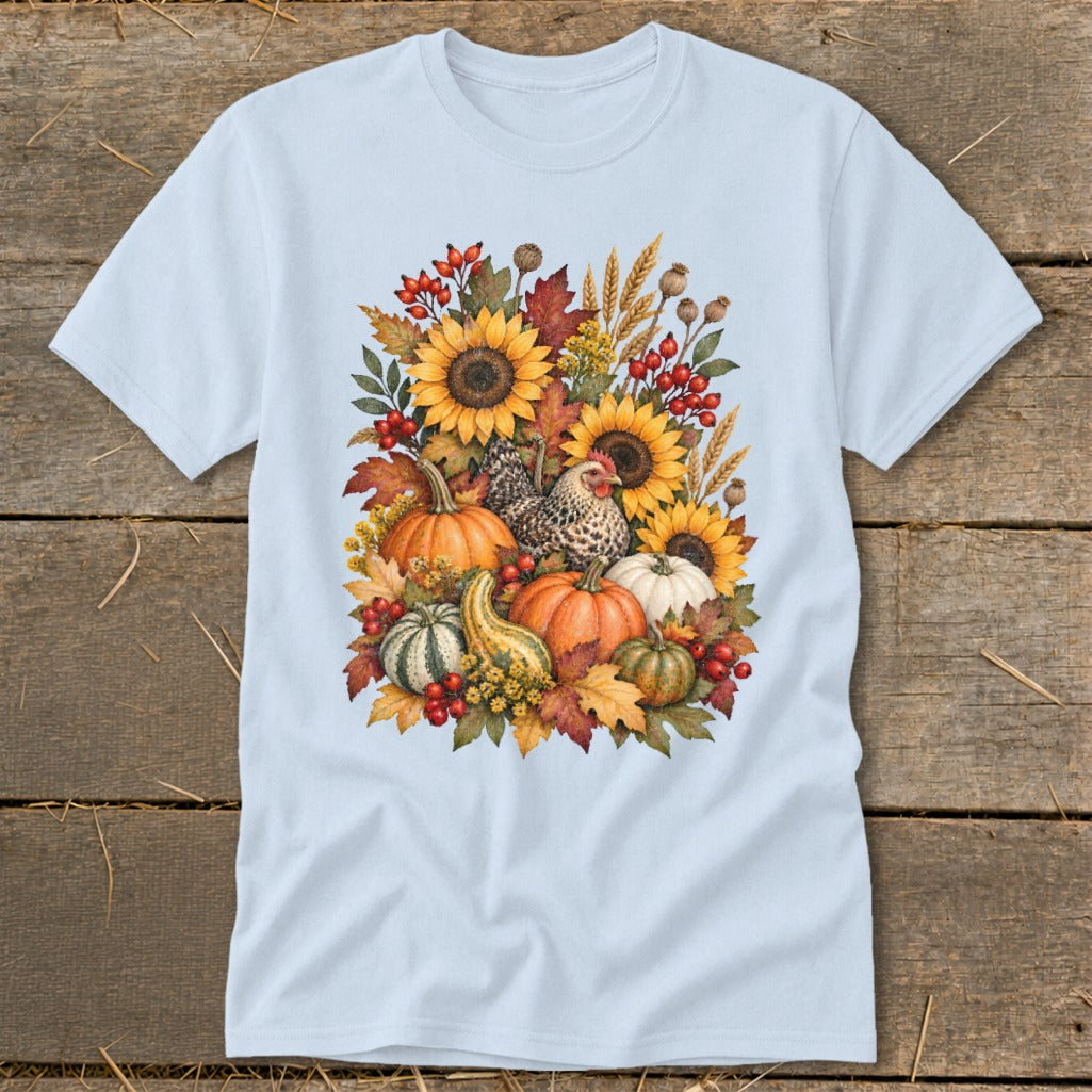 Light blue t-shirt with watercolor fall harvest design featuring sunflowers, pumpkins, gourd, and chicken.