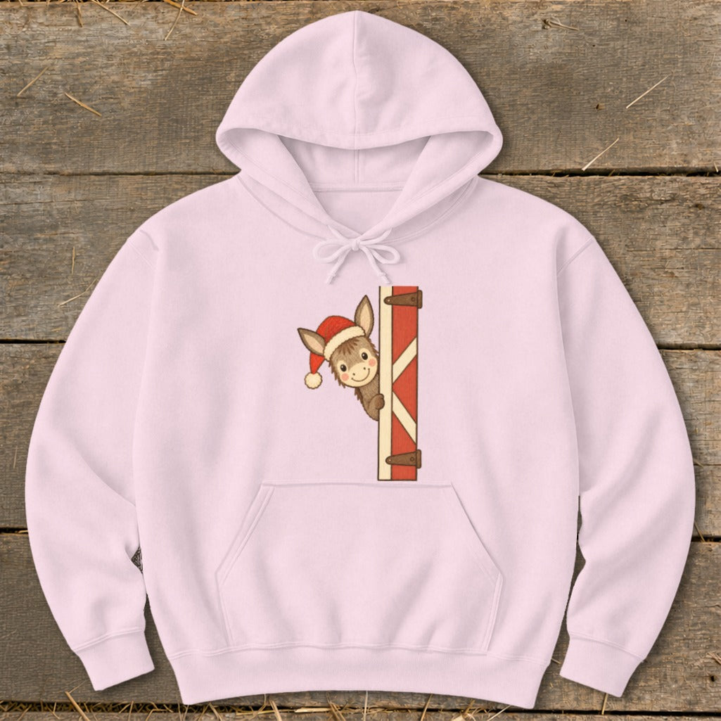 Pink hoodie with a cartoon donkey wearing a Santa hat peeking from behind a gate.
