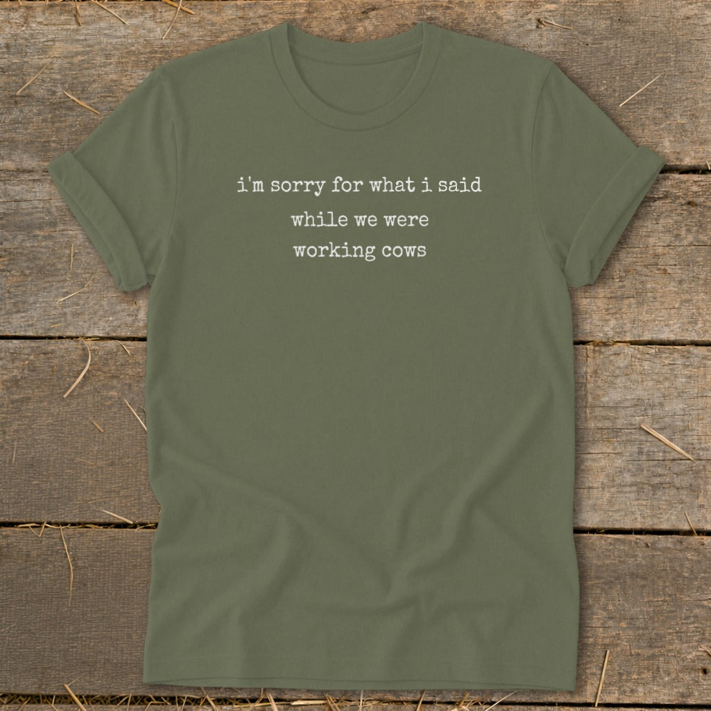 Olive green t-shirt with white text: "I'm sorry for what I said while we were working cows".