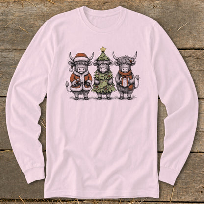 Three highland cows dressed for Christmas: one in a Santa suit, one as a tree, one with a gift.