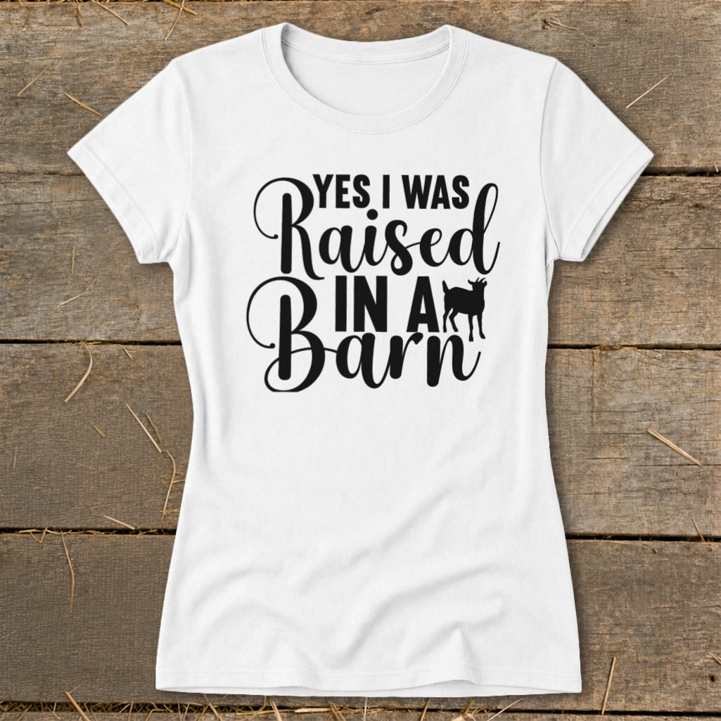 White t-shirt with "YES I WAS Raised IN A Barn" text and goat silhouette.