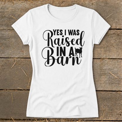 White t-shirt with "YES I WAS Raised IN A Barn" text and goat silhouette.