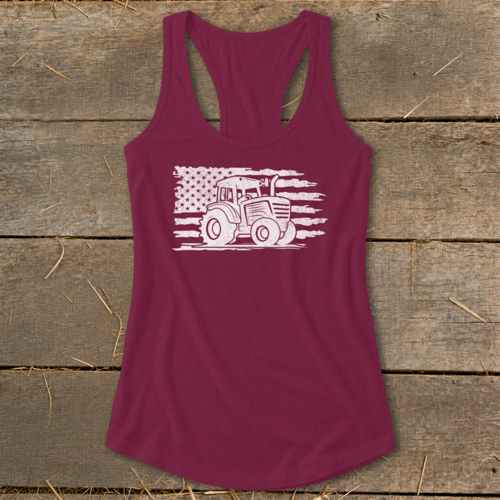 Burgundy tank top with a white distressed tractor on an American flag graphic.