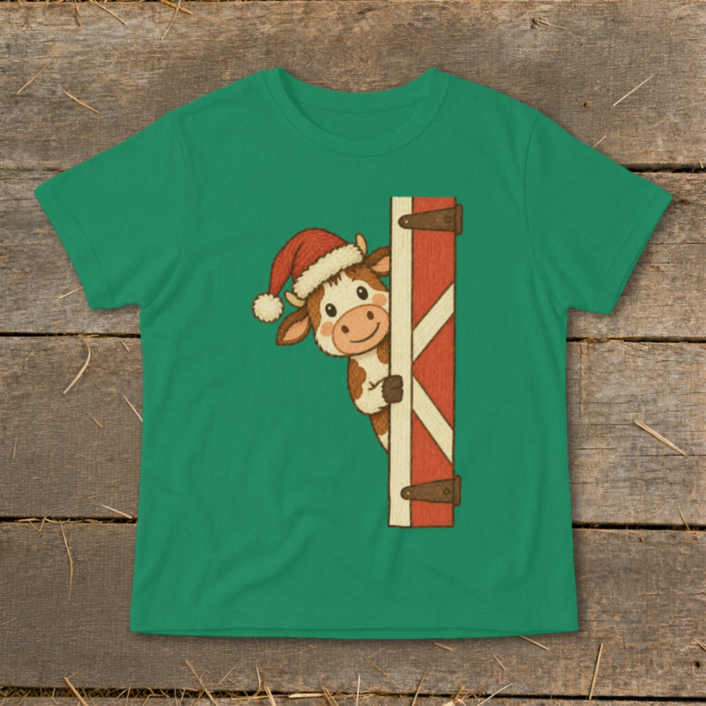 Cartoon cow in Santa hat peeking around a red barn door.