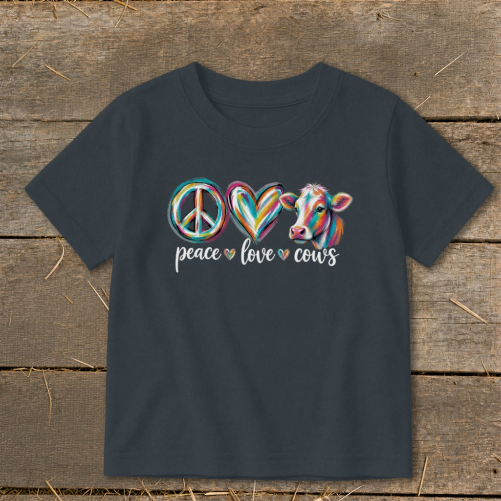 Dark gray t-shirt with peace sign, heart, and cow graphic with text.