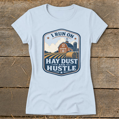 Light blue t-shirt with "I RUN ON HAY DUST AND HUSTLE" farm graphic.
