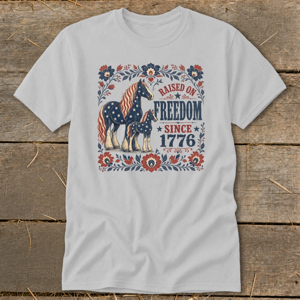 Gray t-shirt with patriotic horses and "Raised on Freedom Since 1776" text.