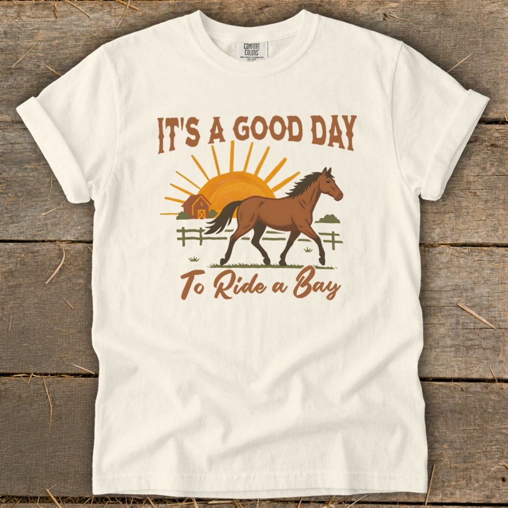 White t-shirt with "It's a Good Day To Ride a Bay" and a horse graphic.