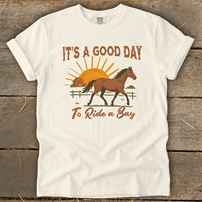 White t-shirt with "It's a Good Day To Ride a Bay" and a horse graphic.