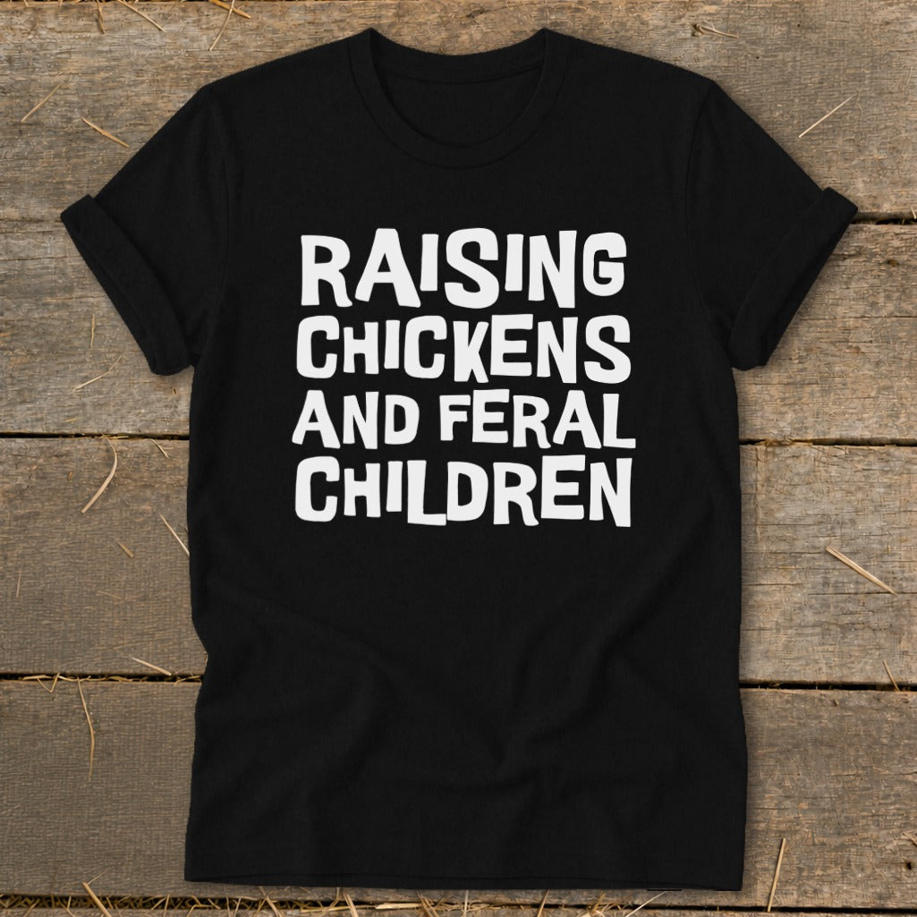 Black t-shirt with white text reading "Raising Chickens and Feral Children".