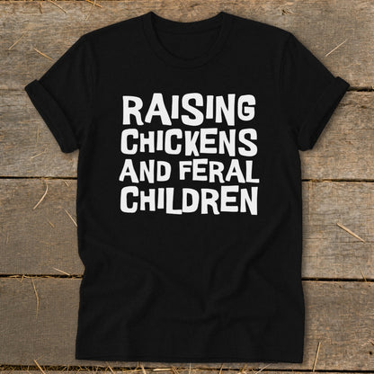 Black t-shirt with white text reading "Raising Chickens and Feral Children".