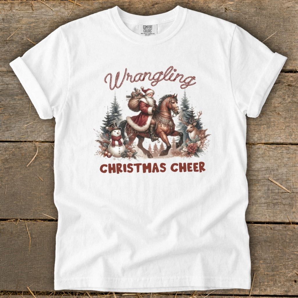 White t-shirt with "Wrangling Christmas Cheer" graphic featuring Santa on horseback.
