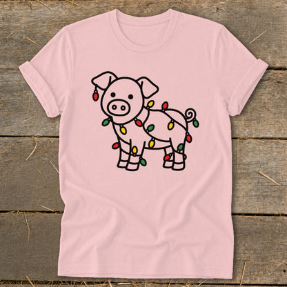 Light pink t-shirt featuring a line drawing of a pig wrapped in Christmas lights.