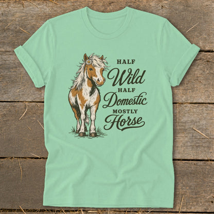 Mint green t-shirt with a horse illustration and text "Half Wild, Half Domestic, Mostly Horse".