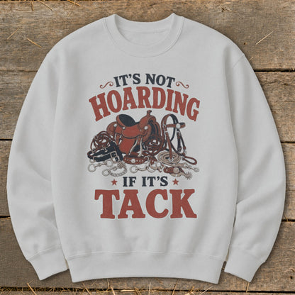 White sweatshirt with "It's Not Hoarding If It's Tack" text and equestrian tack graphic.