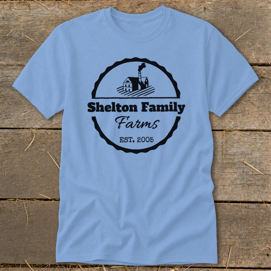 Light blue t-shirt with "Shelton Family Farms EST. 2005" logo and farm graphic.
