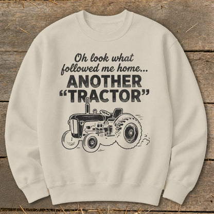 Cream sweatshirt with text "Oh look what followed me home... ANOTHER TRACTOR" and tractor graphic.
