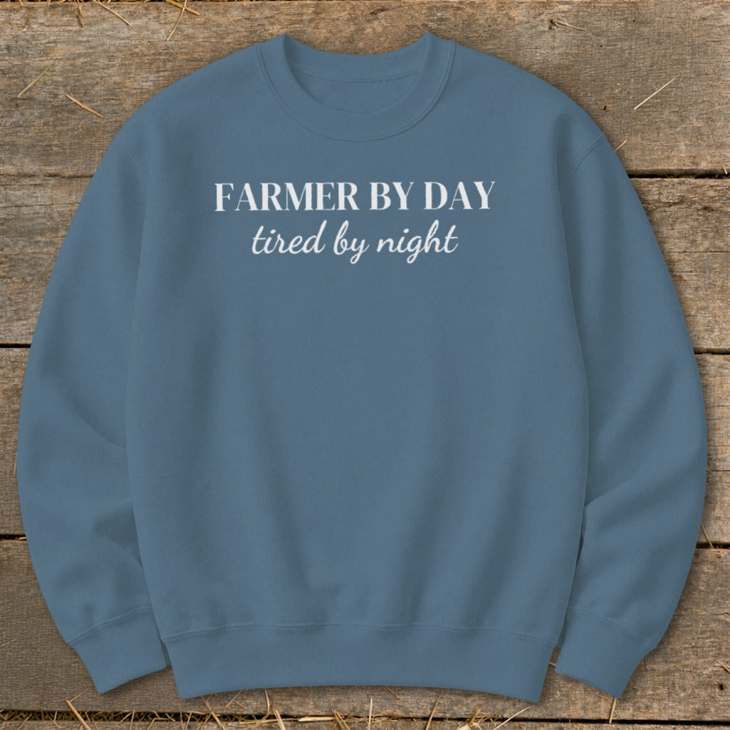 Blue sweatshirt with white text that reads "Farmer by day tired by night".
