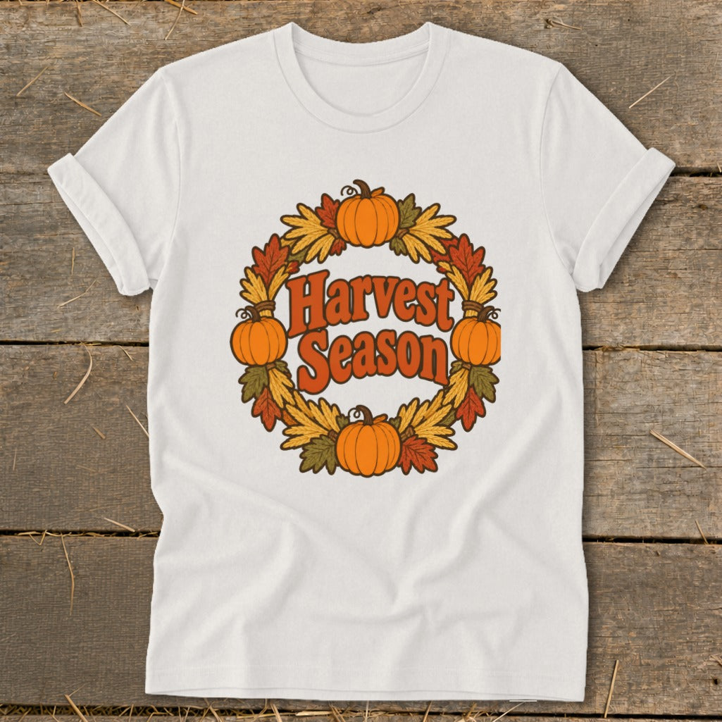 White t-shirt with "Harvest Season" text in a pumpkin and leaf wreath.