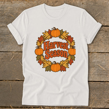 White t-shirt with "Harvest Season" text in a pumpkin and leaf wreath.