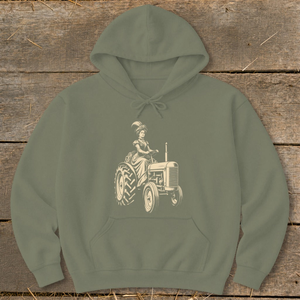 Olive green hoodie with a graphic of a woman in vintage clothing driving a tractor.