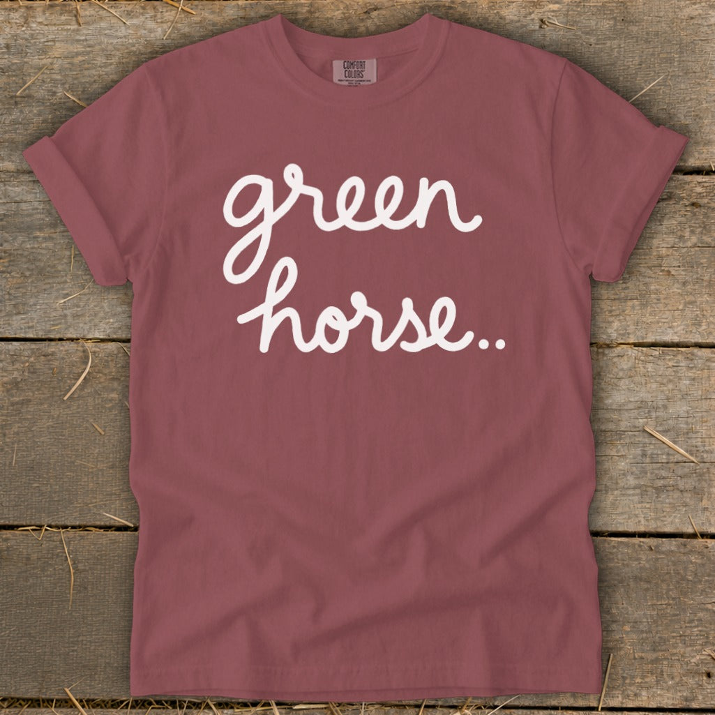 Maroon t-shirt with white script text "green horse.."